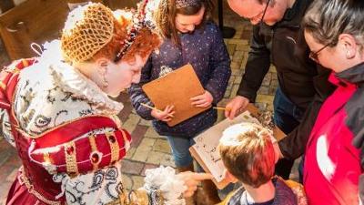 Children and adults looking at a map 